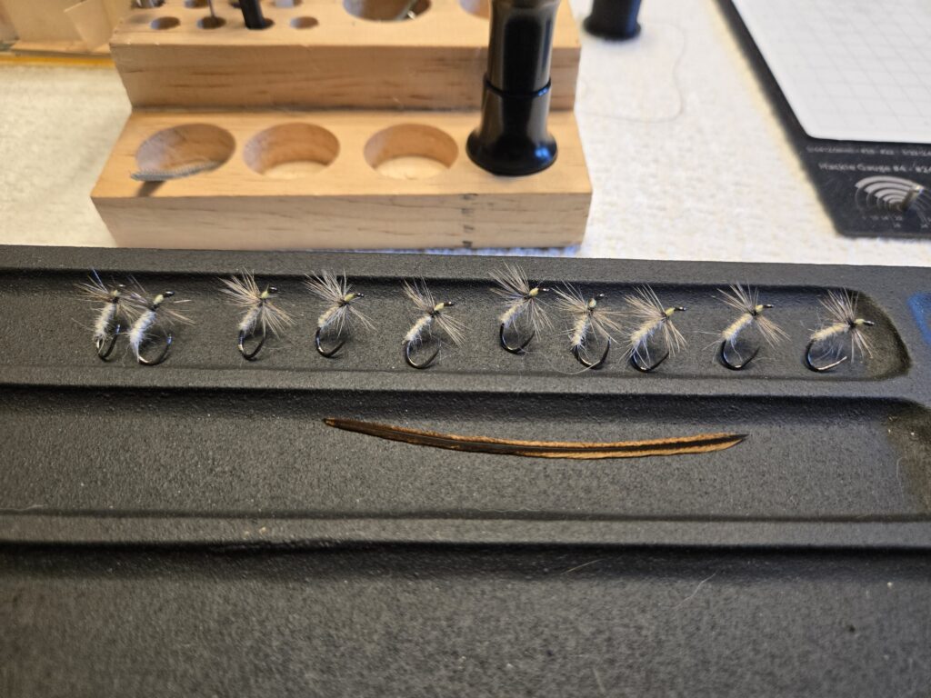 A row of identical pale kebari fishing flies from Jay's Kebari Shop